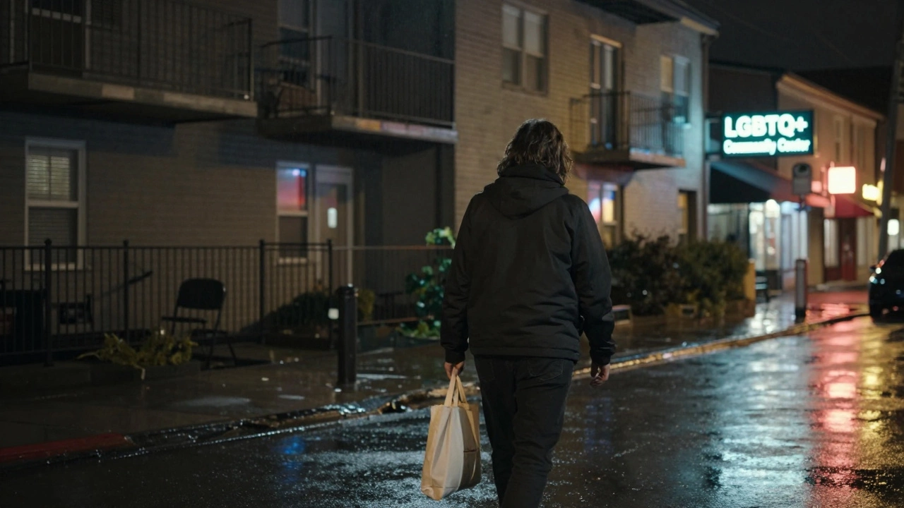 A person walking away from an apartment building at night, carrying a tote bag, under soft city lights reflecting on wet pavement.
